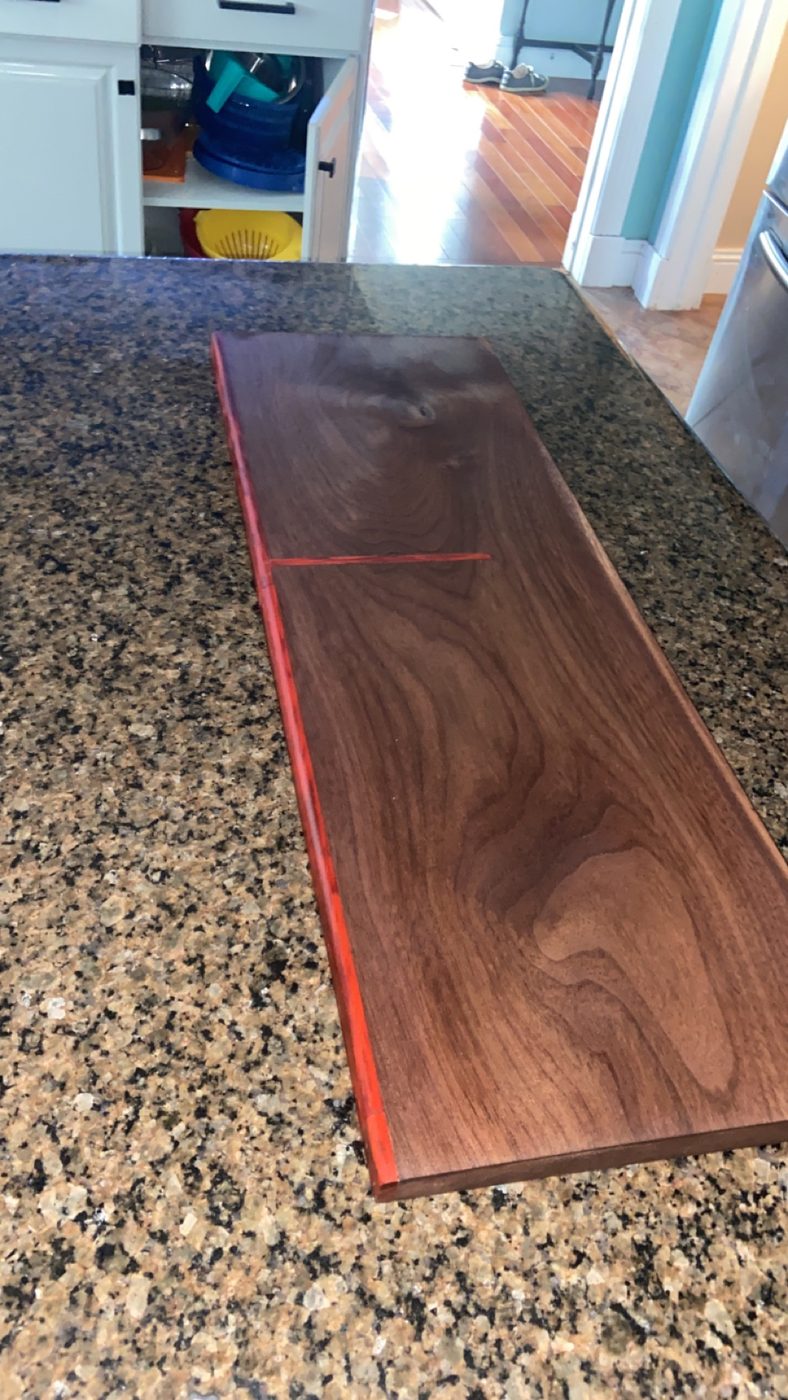 Walnut serving board with red epoxy inlay
