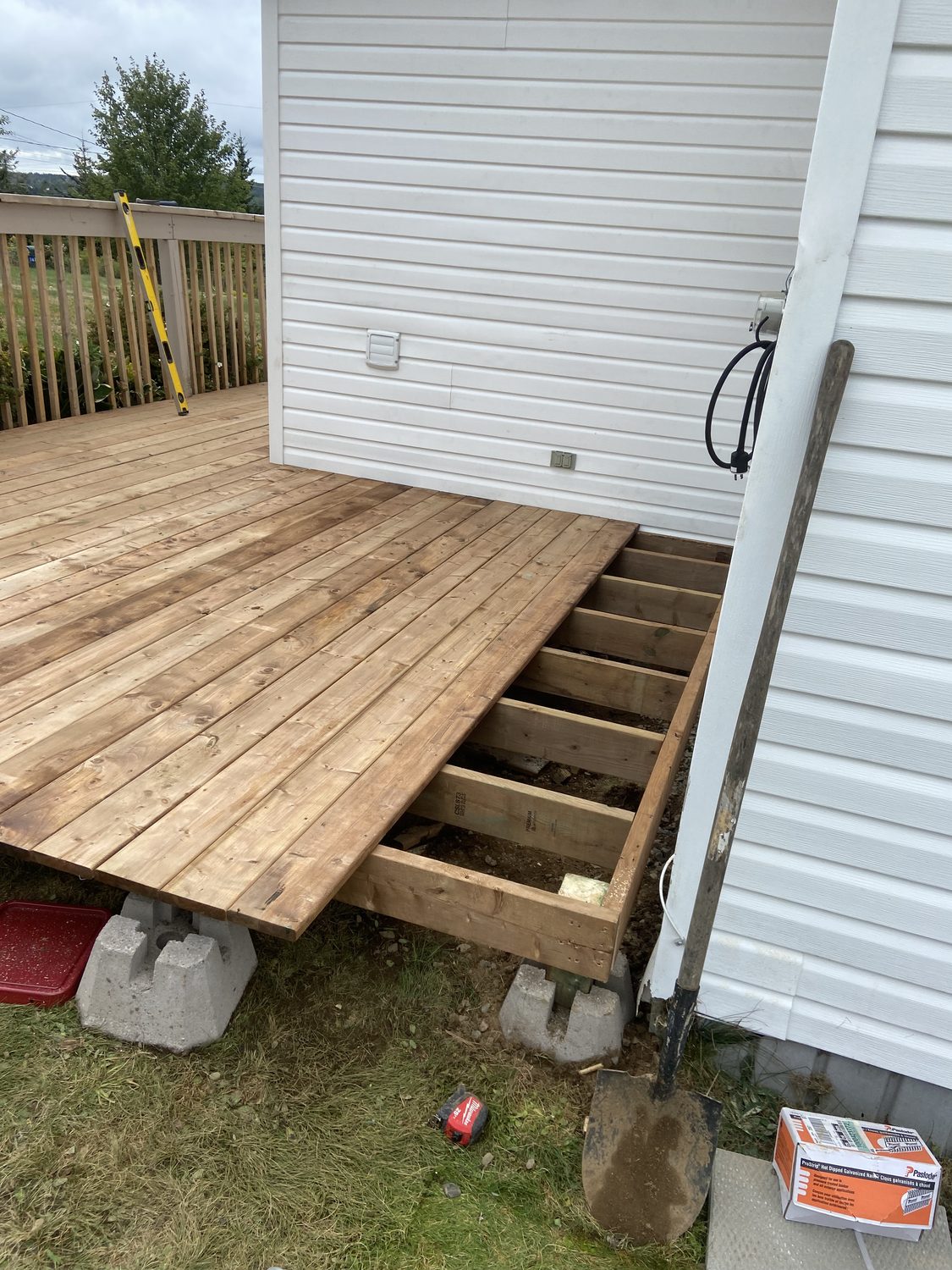 Deck build in progress with joists on piers and boards going down
